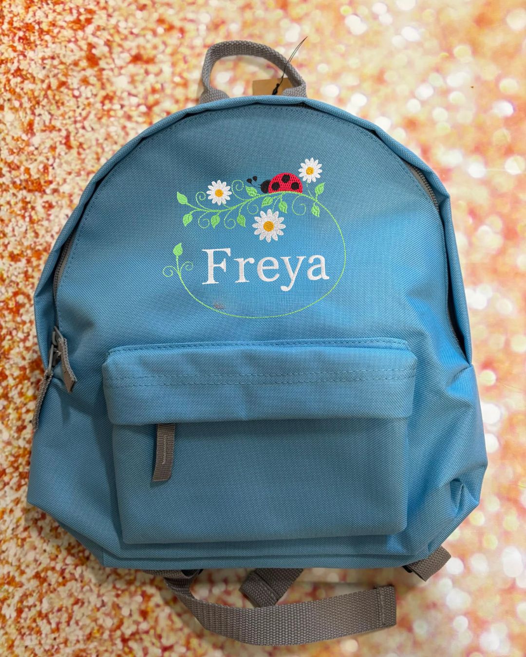 Personalised Nursery / Pre-School mini embroidered rucksack. Choice of colour bag. Childs small rucksack, Ladybird & Flowers Design